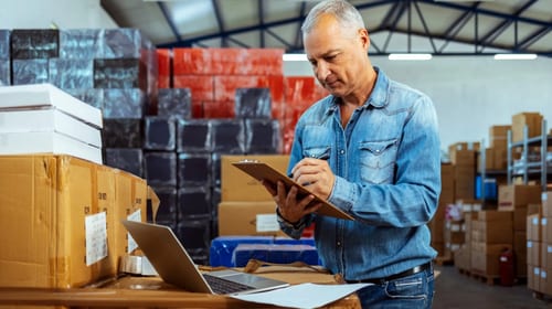 Business owner reviewing cargo insurance policy documents